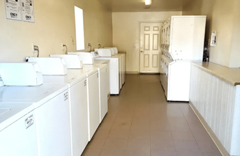 Laundry facilities with multiple washers and dryers at Foothills Court Phoenix, Arizona 85029